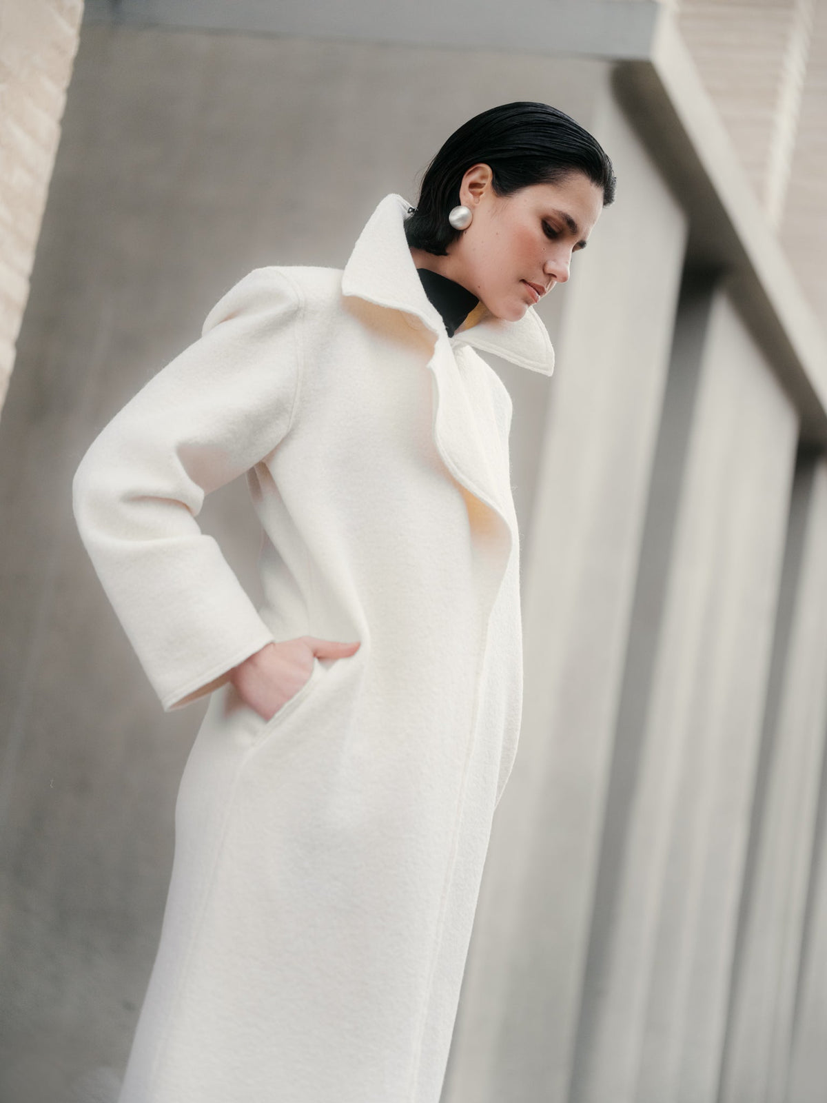 Model wearing Off-white boiled wool long coat by Zamsee—timeless, warm, and consciously crafted.