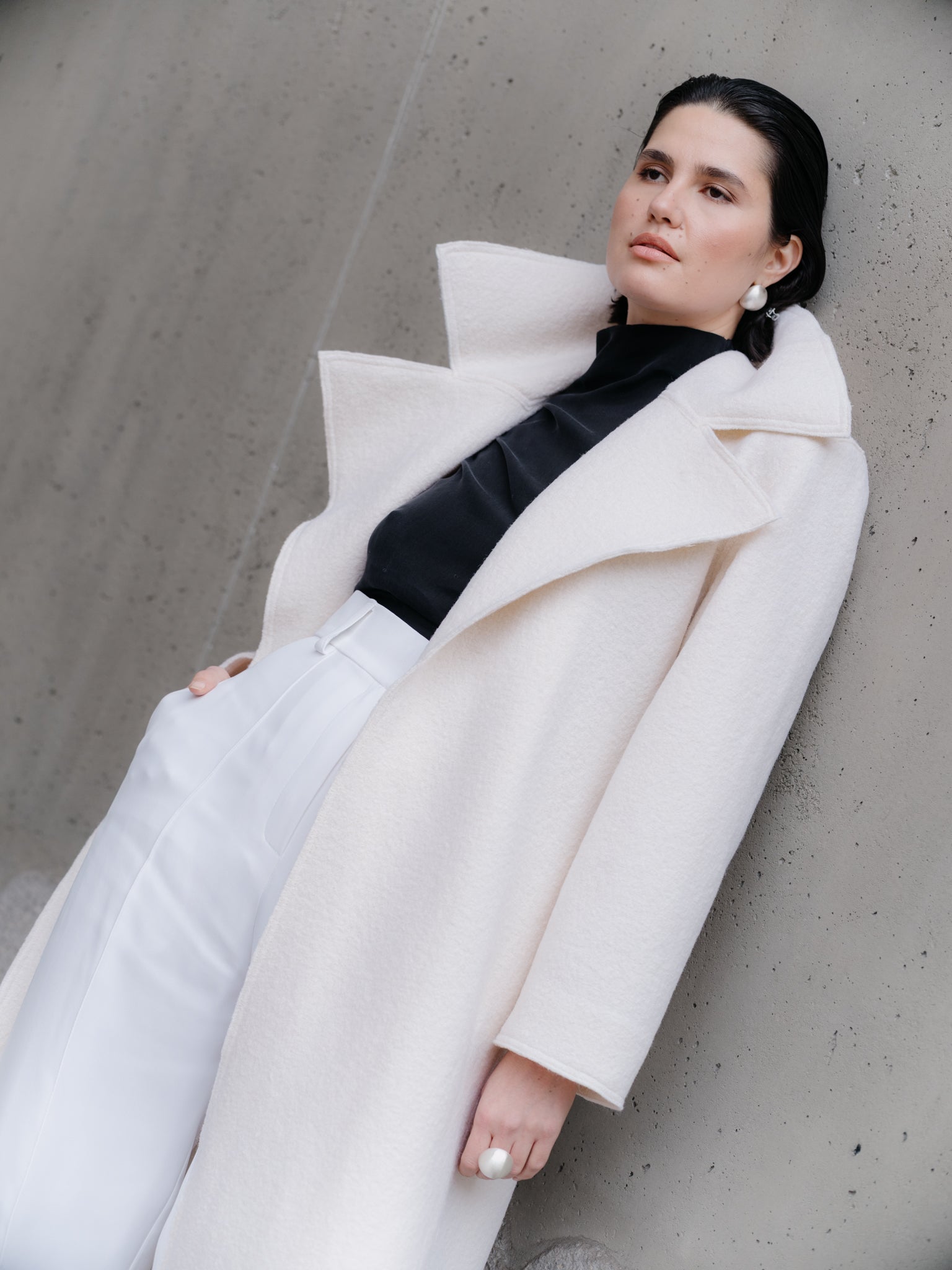 Model wearing Off-white boiled wool long coat by Zamsee—timeless, warm, and consciously crafted.