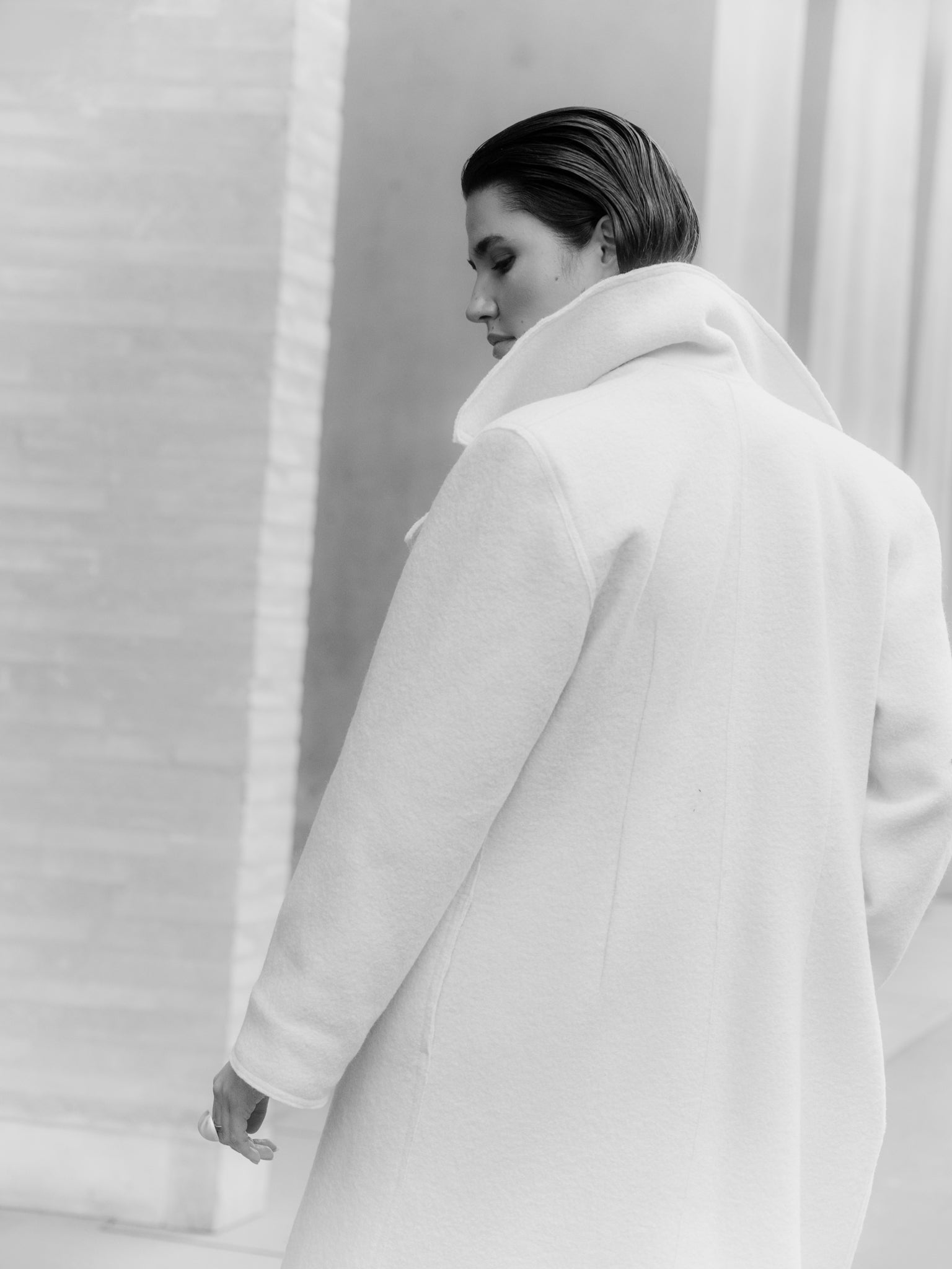 Model wearing Off-white boiled wool long coat by Zamsee—timeless, warm, and consciously crafted.