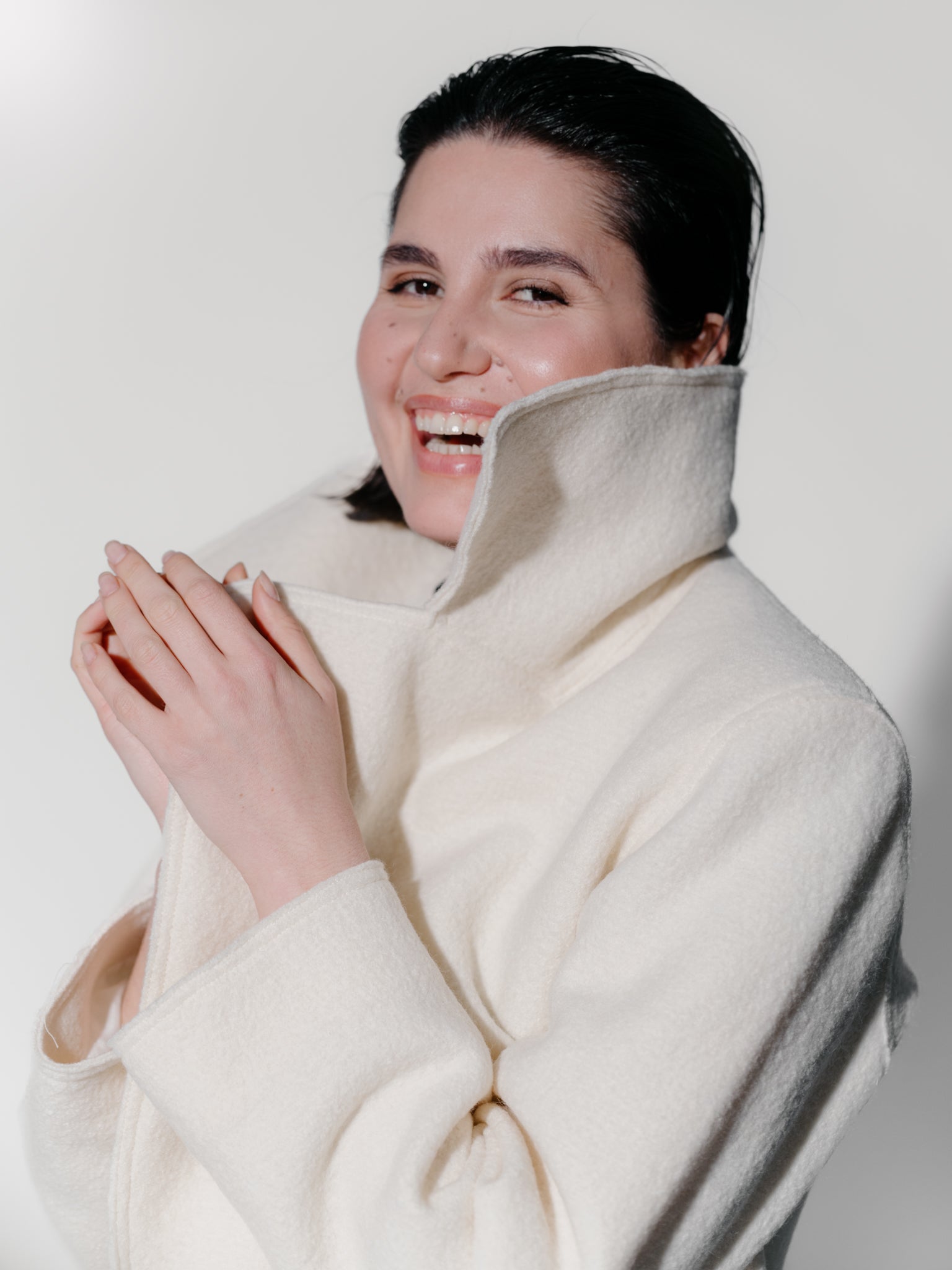 Model wearing Off-white boiled wool long coat by Zamsee—timeless, warm, and consciously crafted. 