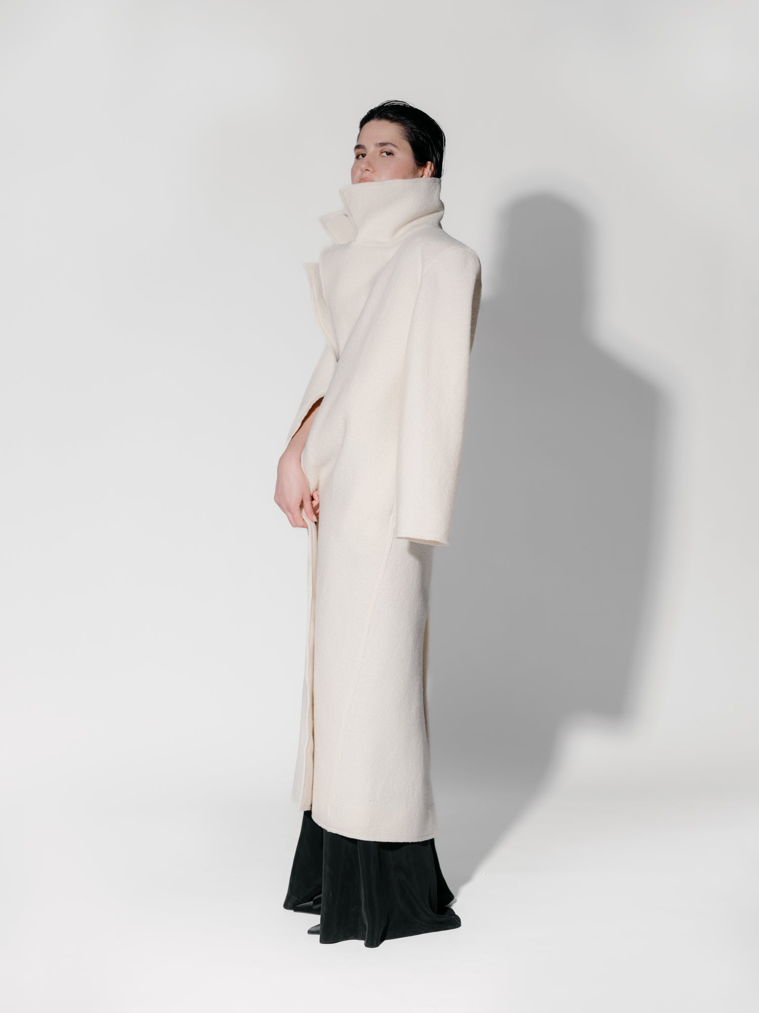 Model wearing Off-white boiled wool long coat by Zamsee—timeless, warm, and consciously crafted. 